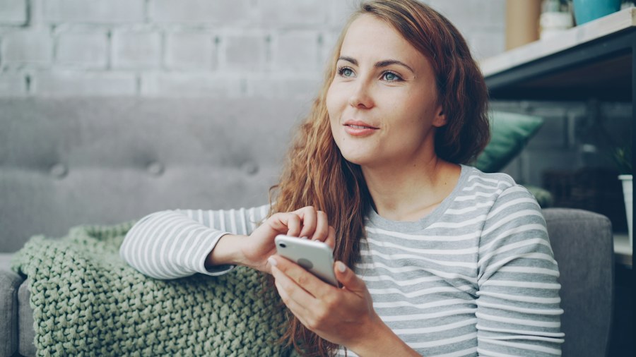 A woman relaxing at home with her phone