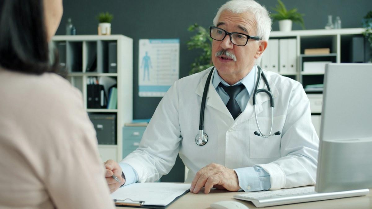 A doctor speaking with a patient during a consultation
